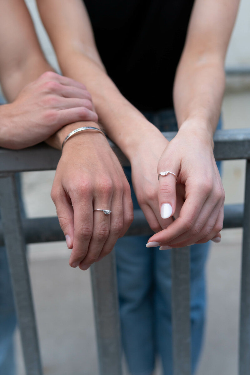 Two models with two hands wearing .925 sterling silver ring sets.