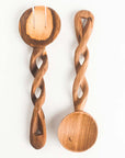 Two olive wood salad servers with twisted handles on a white background