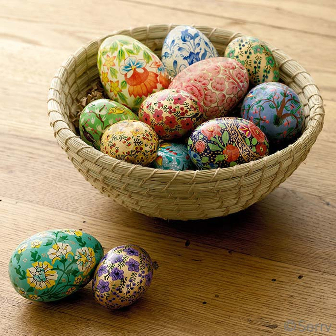 Hand-painted wooden eggs in a bowl