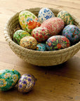 Hand-painted wooden eggs in a bowl