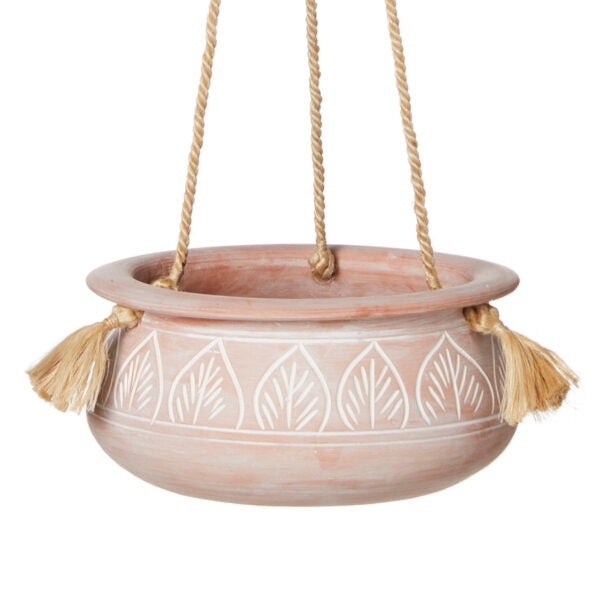 A terracotta hanging planter with etched leaf patterns and a jute hanger