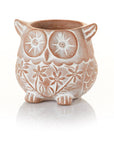 A whitewashed terracotta owl-shaped planter with a drainage hole at the bottom