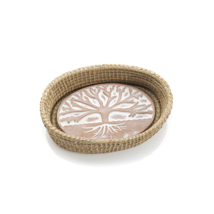 An oval-shaped bread basket made from natural fibers with a terracotta bread warmer inside, featuring a tree of life design.