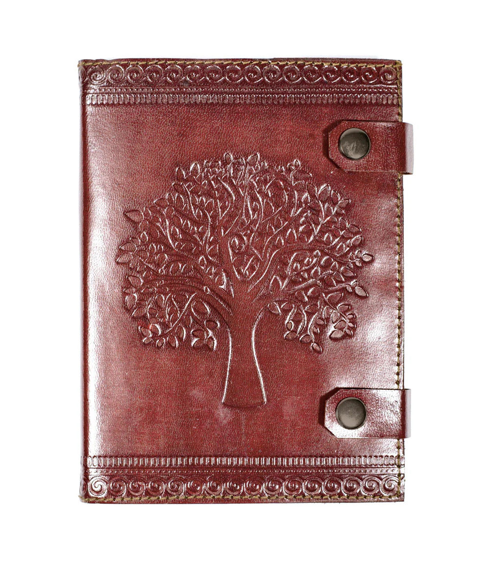 Brown leather notebook with embossed tree of life design on a white background