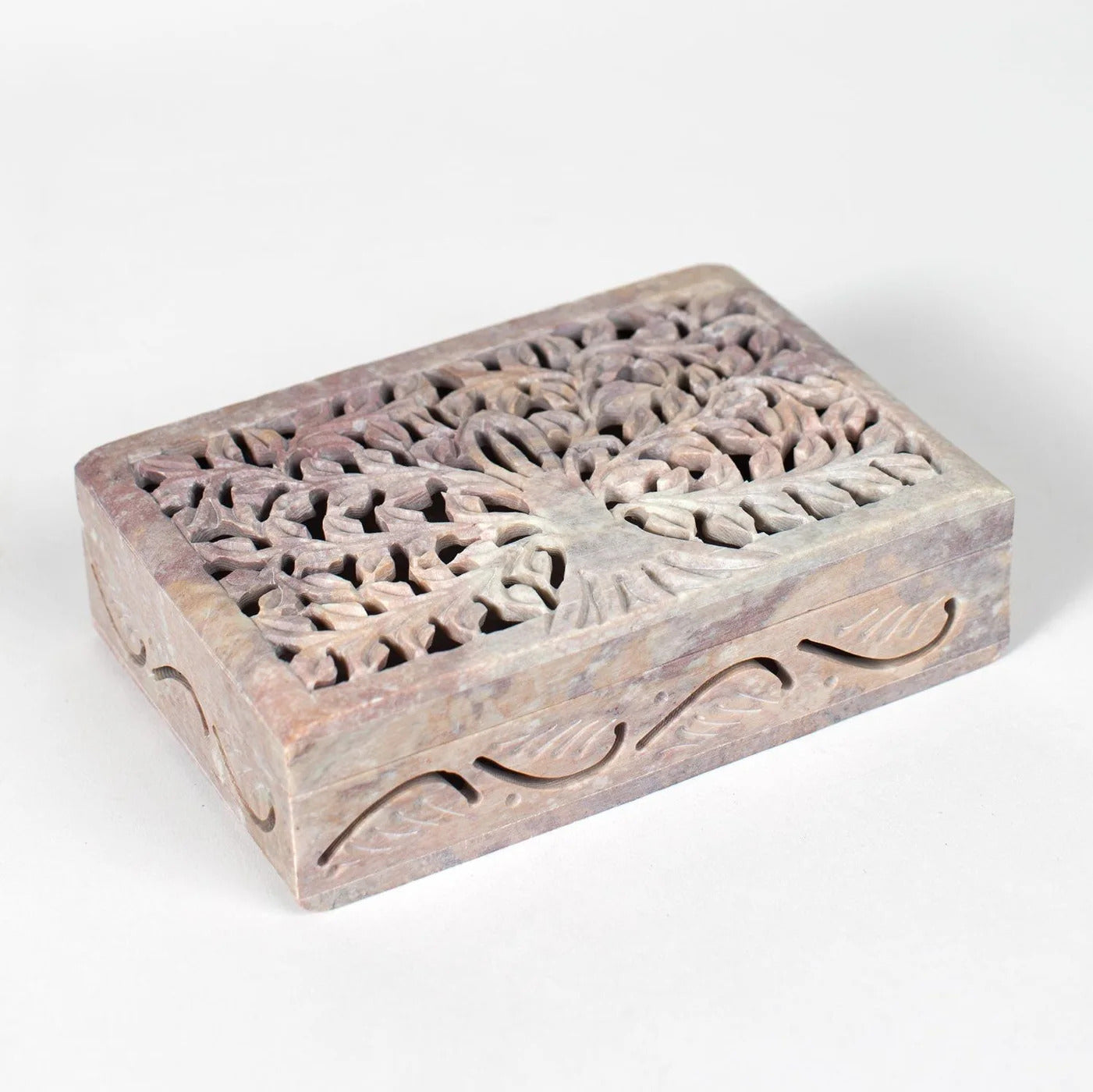 Decorative wooden box with intricate tree carvings on a white background