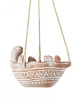 Decorative turtle hanging planter on a white background