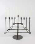 Iron twisted menorah with eight white candles