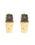 A set of two gold-colored, Star of David-shaped wine bottle stoppers affixed to a natural cork