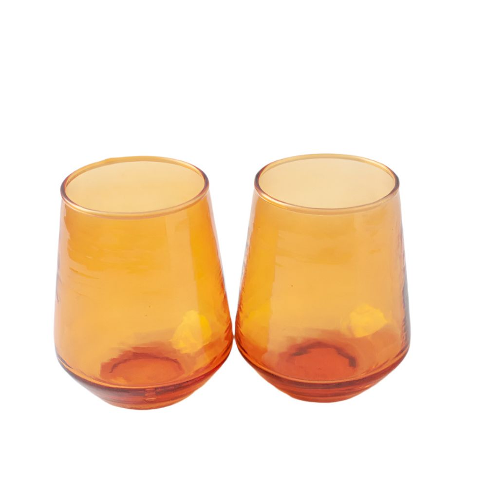 Two handblown hammered amber drinking glasses with a textured finish, placed side by side
