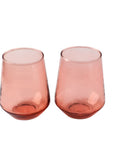 Two handblown hammered blush pink drinking glasses with a textured finish, set on a white background