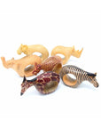 A collection of six wooden napkin rings, each shaped like a different safari animal, including a lion, cheetah, elephant, rhinoceros, giraffe, and zebra, carved from African Mahogany