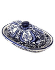 A handmade ceramic butter dish with a blue floral pattern on a white background, crafted by Encantada