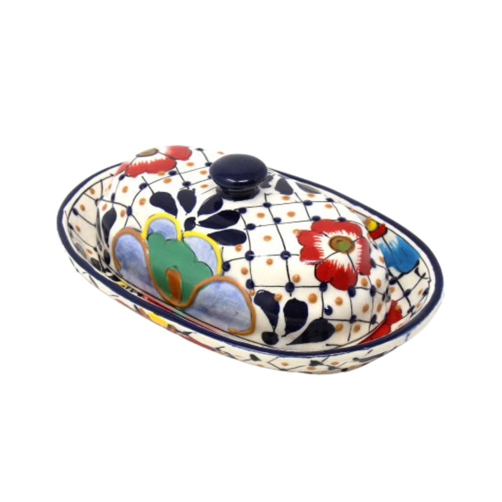 A traditional Mexican pottery butter dish with a floral and dot pattern design, featuring a lid