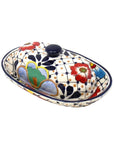 A traditional Mexican pottery butter dish with a floral and dot pattern design, featuring a lid