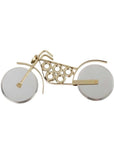 A gold-colored motorcycle-shaped pizza cutter with a stainless steel blade and wheels designed to resemble motorcycle tires