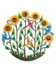 A circular metal wall art featuring a vibrant hand-painted design with sunflowers, birds, and greenery on a white background