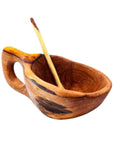 A handcarved olive wood salt pot with a spoon, with natural color variations