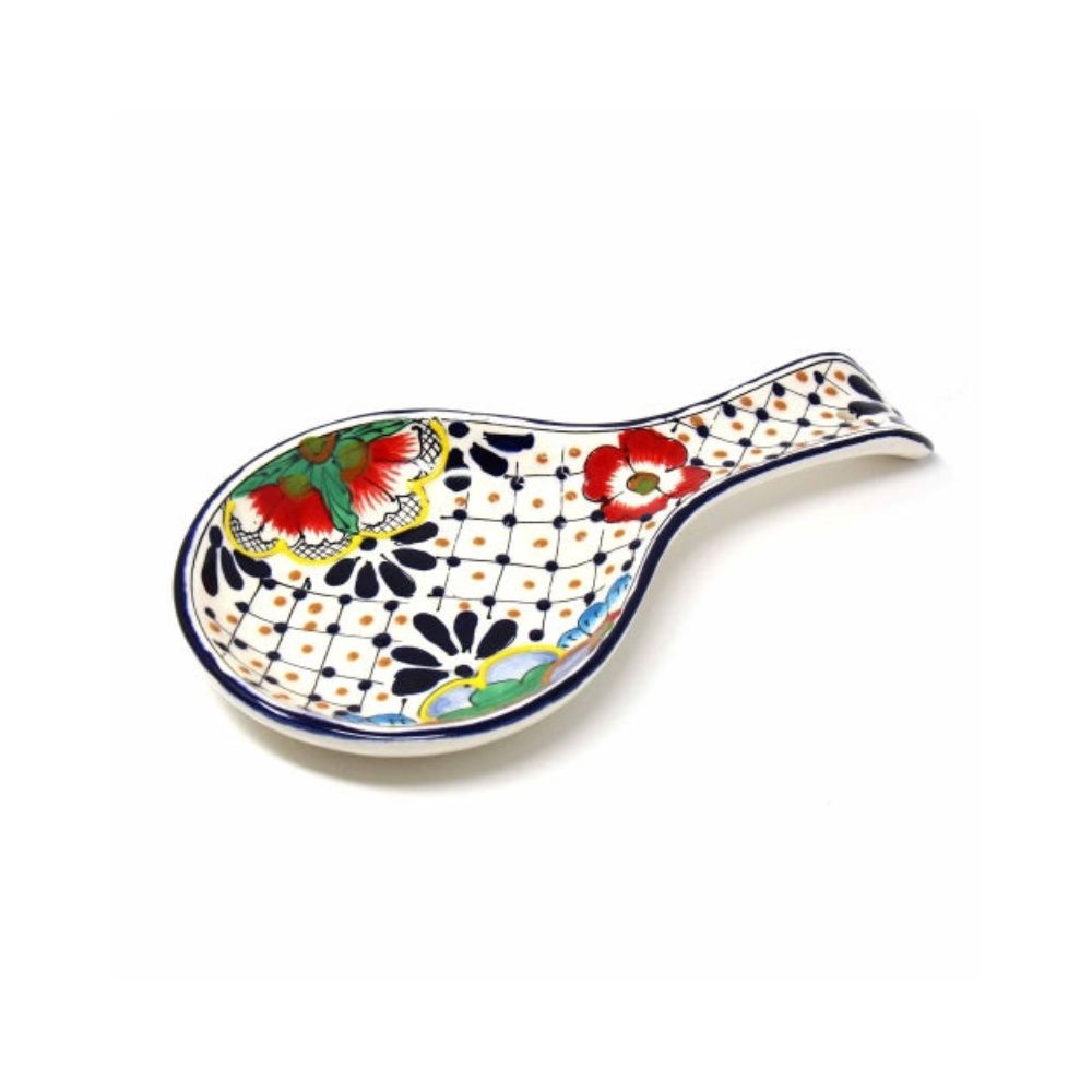 A multicolored, handcrafted ceramic spoon rest with a floral and geometric pattern