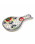 A multicolored, handcrafted ceramic spoon rest with a floral and geometric pattern