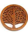 A round wooden trivet with a tree of life design in the center, crafted from sheesham wood
