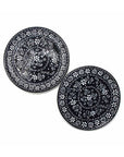 Two traditional Mexican pottery dinner plates with black and white floral patterns