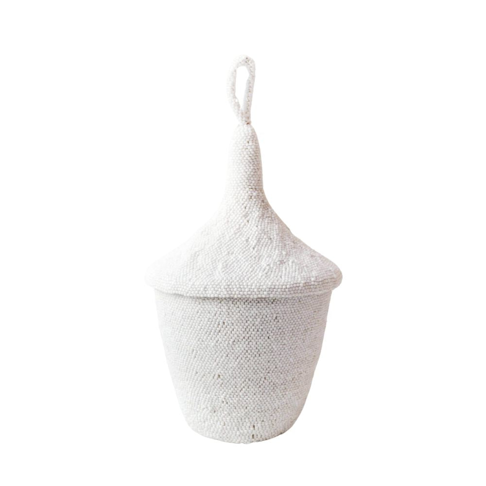 A white hand-beaded peace basket with a woven sisal interior, used for storing small items like candies or keys. The basket is decorated with a textured pattern using locally sourced beads