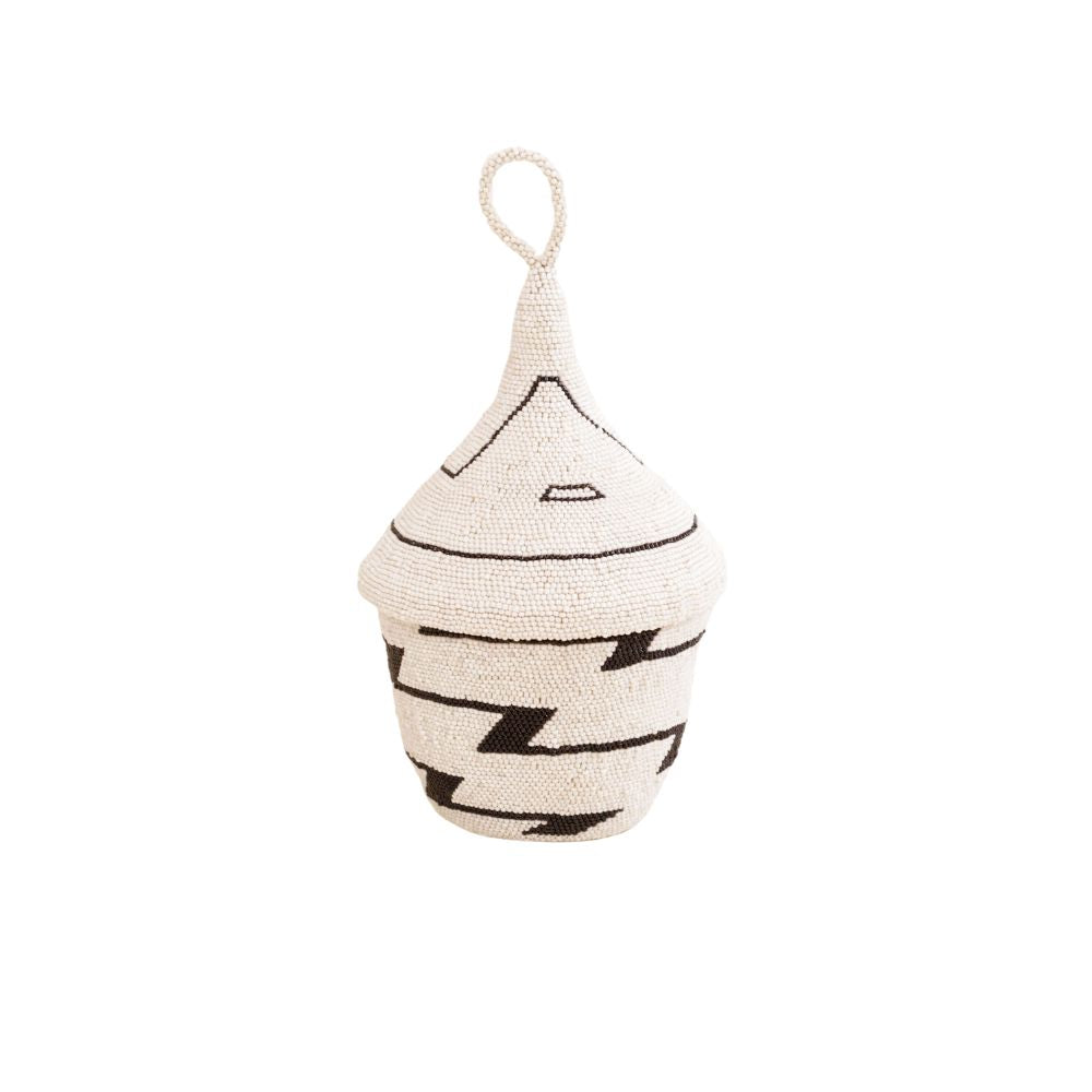 A hand-beaded white and black geometric patterned basket with a woven sisal interior, intended as a decorative home decor piece