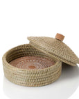 Woven basket and bread warmer with a lid on a white background