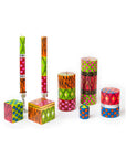 Colorful animal print candles with various patterns on a white background