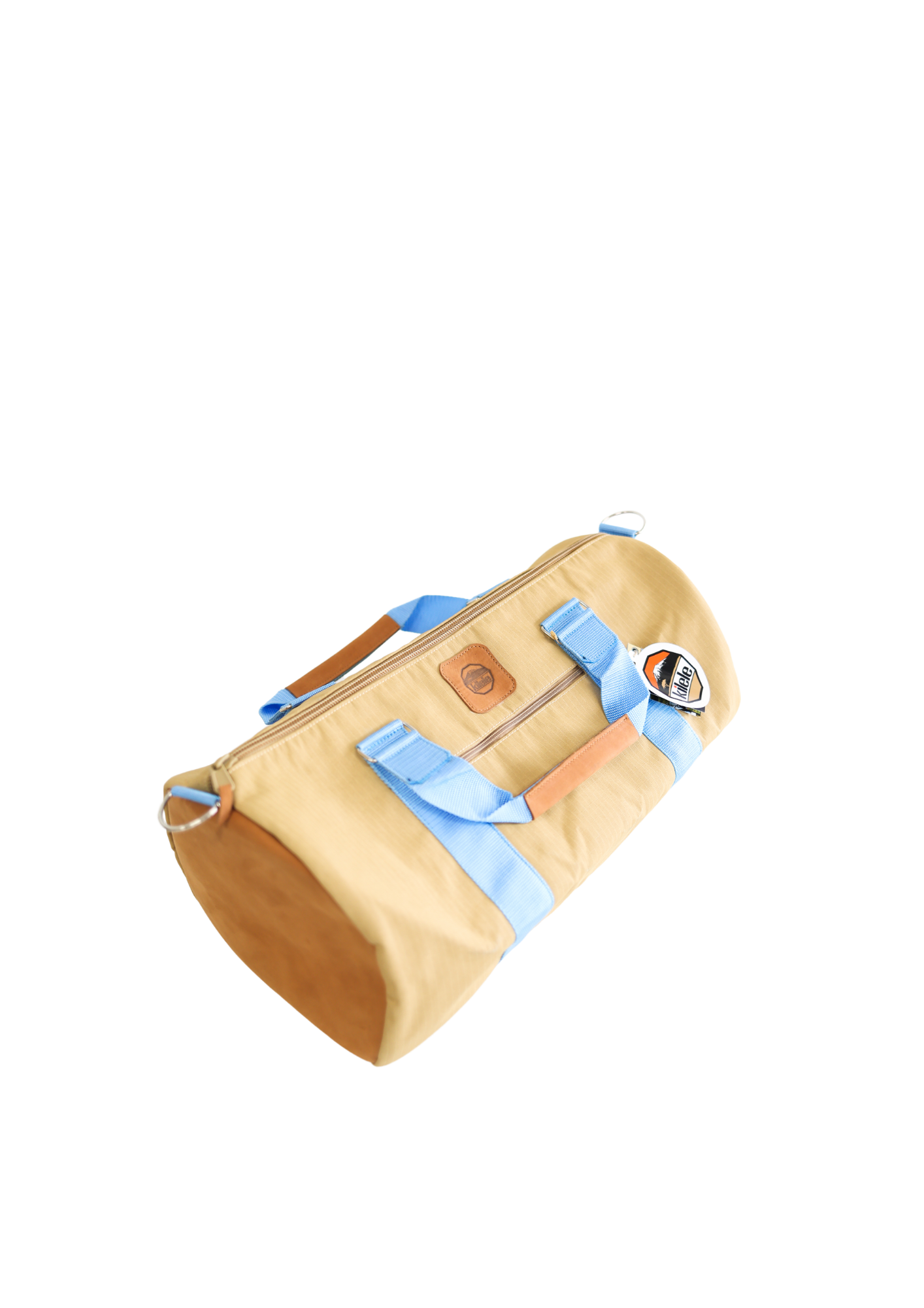 A beige and light blue duffel bag with black straps and a tan leather bottom, standing upright on a plain background.