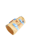 A beige and light blue duffel bag with black straps and a tan leather bottom, standing upright on a plain background.