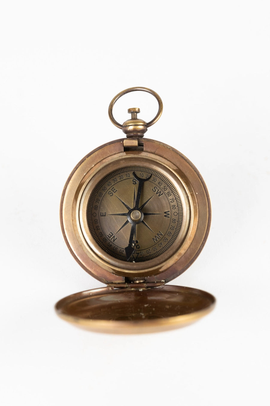 Bronze pocket compass on a white background