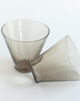 Two clear glass tumblers on a white background