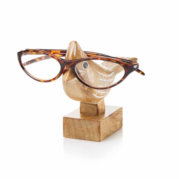 A pair of glasses resting on a wooden stand carved in the shape of a cardinal