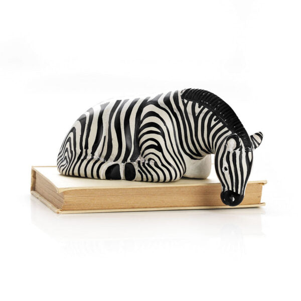 A sculpture of a striped zebra resting its head on a wooden shelf, made from natural soapstone