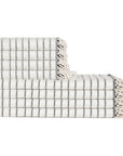 Stack of white and gray striped towels with fringed edges on a white background