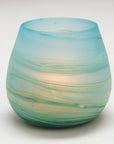 Turquoise glass candle holder on a white background