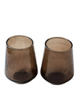Two handblown hammered smoke-colored drinking glasses with a textured surface, set on a white background