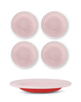 Set of four pink bowls with a red plate on a white background