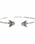 Up close picture of the bees on a cuff bracelet crafted from brass and a silver plate with black antique finish.