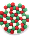 A round coaster made of white, red, and green felt balls arranged in a geometric pattern