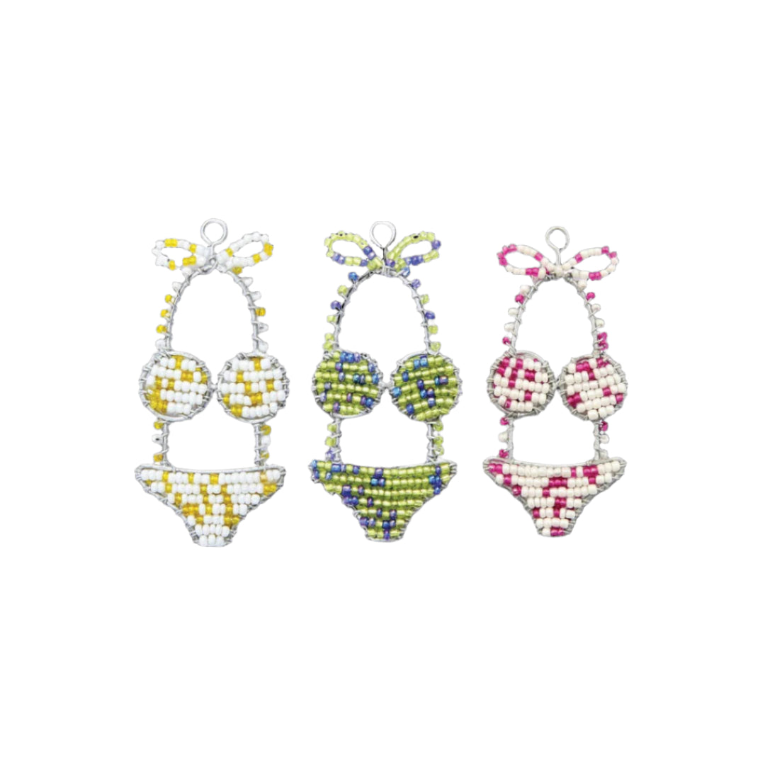 Three colorful bikini-shaped keychains on a black background