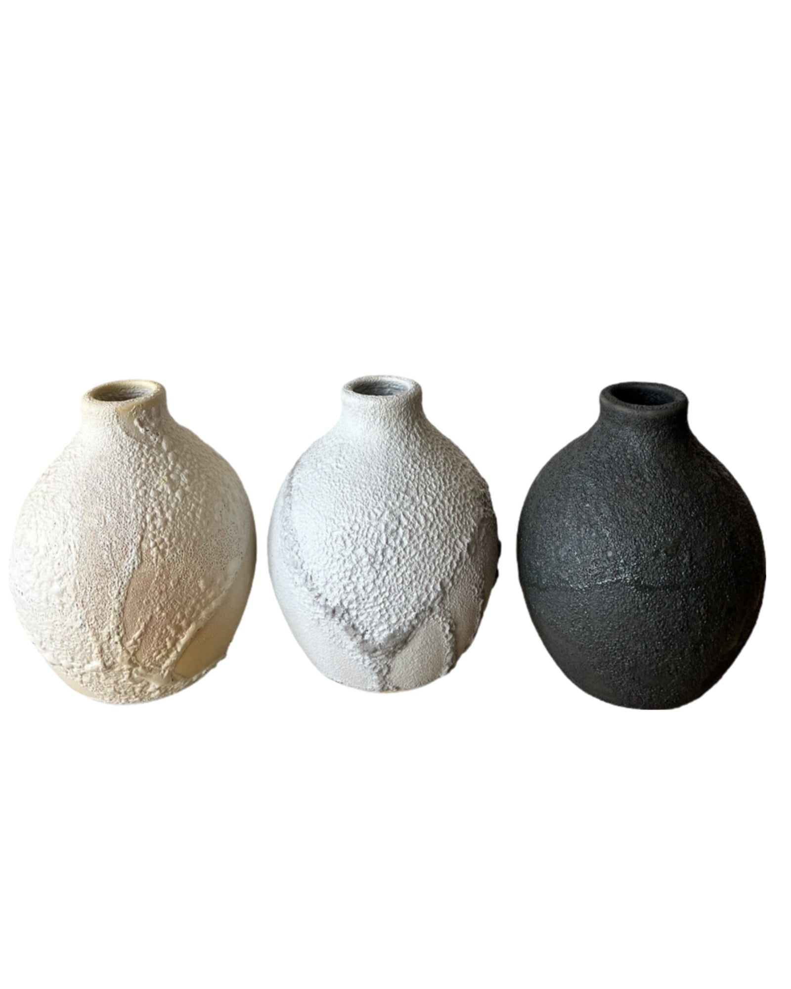 Three textured ceramic vases on a white background