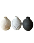 Three textured ceramic vases on a white background