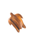 A small, hand-crafted acacia wood dish in the shape of a turtle