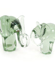 Two recycled glass elephant figurines with a clear glass trunk and a smooth and polished finish