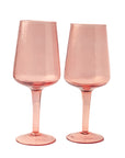 A set of two handblown hammered blush pink wine glasses with a textured surface