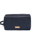 Navy blue toiletry bag with a brown leather patch on a white background