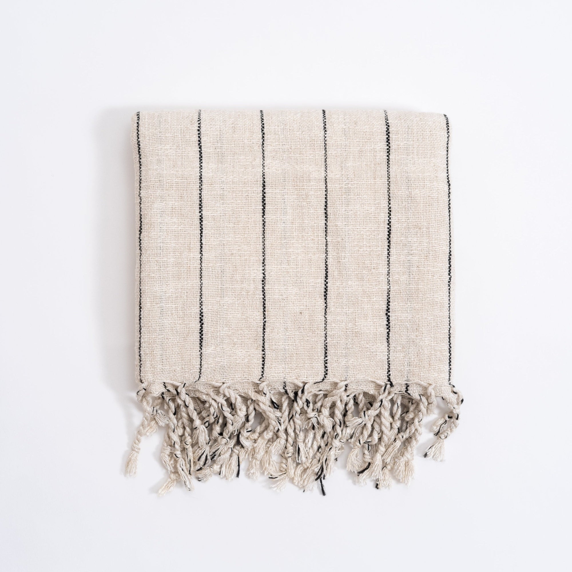 Striped towel with fringes on a white background