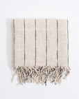 Striped towel with fringes on a white background
